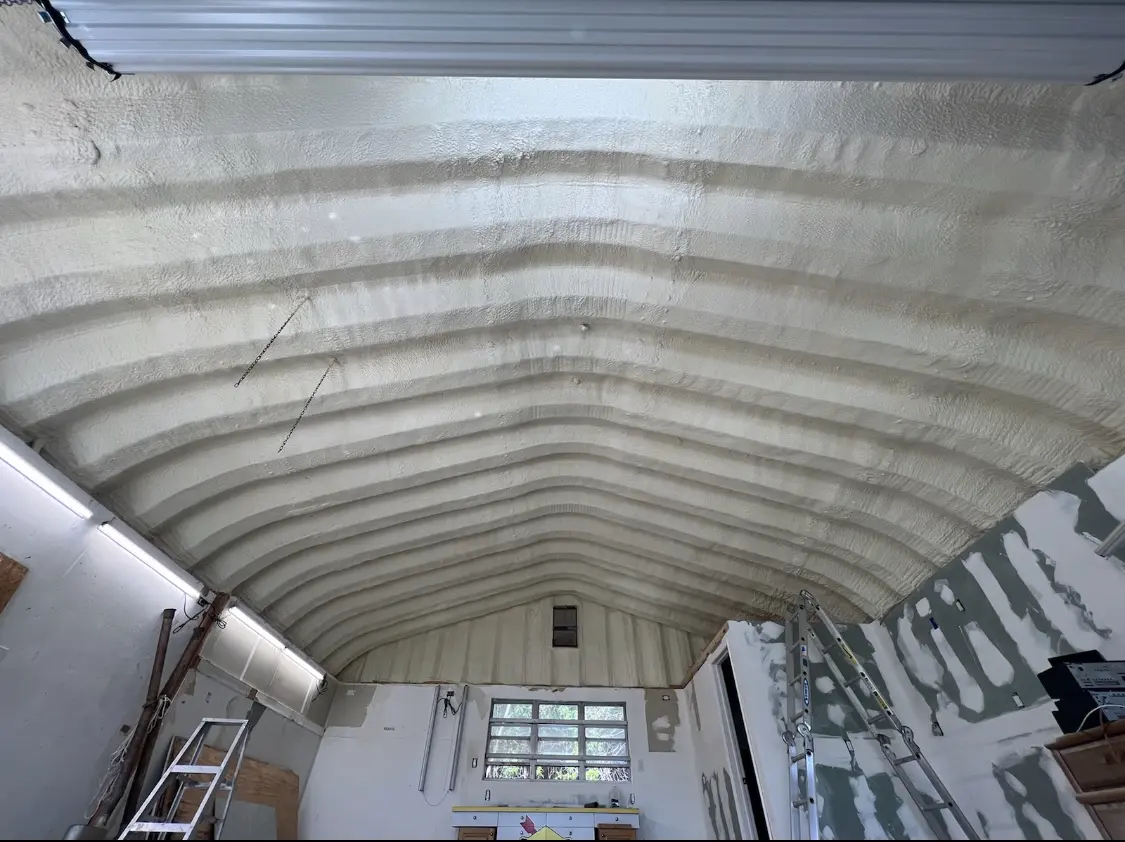 Spray polyurethane foam applied to the underside of a metal roof deck in Hastings